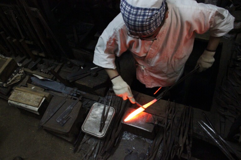 Japanese blacksmith making kitchen knives