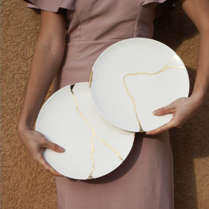 kintsugi plates held by woman