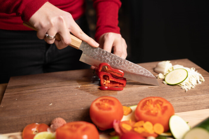 sakai kyuba classic cherry santoku knife cutting peppers