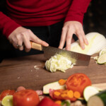 woman cutting veggies with sakai kyuba classic nakiri