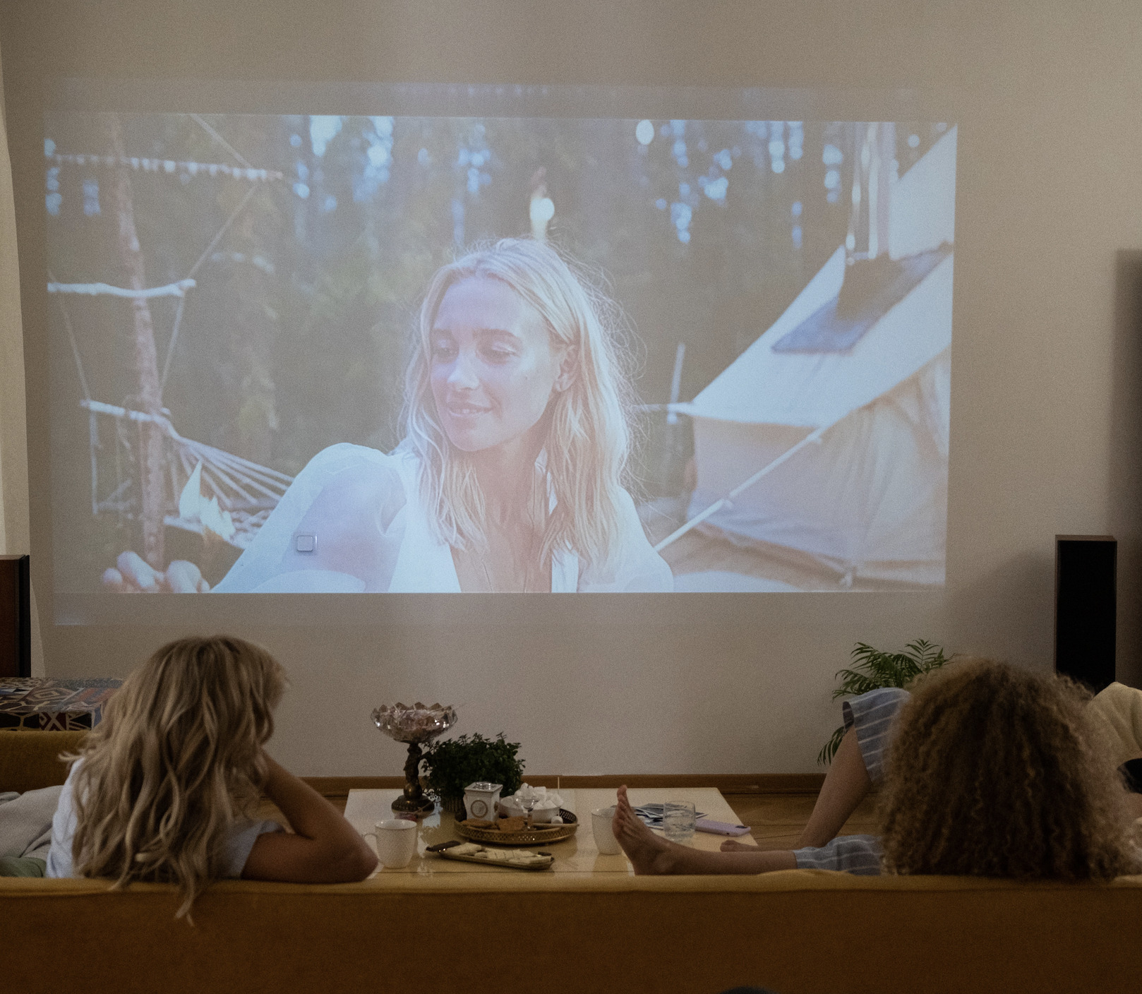 Women watching a movie on a projector screen 
