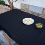 Linen Tablecloth Stonewashed – Off Black, on outdoors table