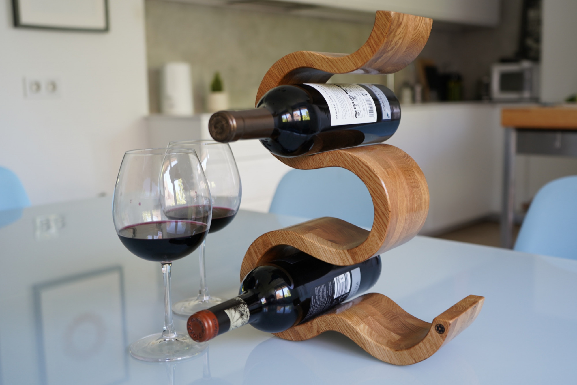 Oak wine rack with two wines on kitchen table
